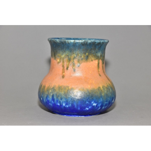 208 - RUSKIN POTTERY, an elephant's foot shaped vase, covered in bands of green, orange and blue glazes, i... 