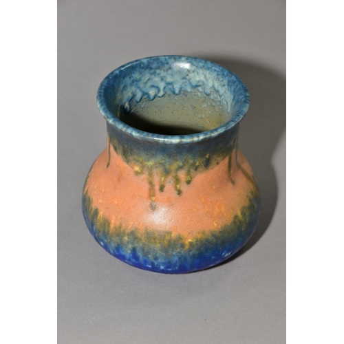 208 - RUSKIN POTTERY, an elephant's foot shaped vase, covered in bands of green, orange and blue glazes, i... 