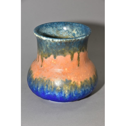 208 - RUSKIN POTTERY, an elephant's foot shaped vase, covered in bands of green, orange and blue glazes, i... 