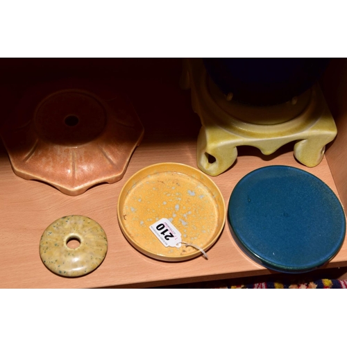 210 - RUSKIN POTTERY, an orange glazed octagonal stand impressed Ruskin England, diameter approximately 15... 