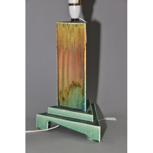 211 - RUSKIN POTTERY, a triangular section moulded lamp base, matt green and orange gloss crystalline glaz... 