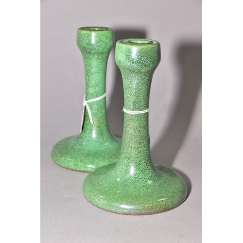 218 - RUSKIN POTTERY, a pair of candlesticks covered in green tea dust glaze, inscribed Ruskin England 192... 