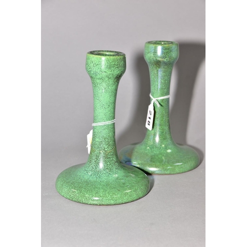 218 - RUSKIN POTTERY, a pair of candlesticks covered in green tea dust glaze, inscribed Ruskin England 192... 