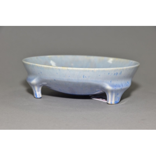 219 - RUSKIN POTTERY, a shallow bowl raised on three feet, blue crystalline and streaked glaze, impressed ... 