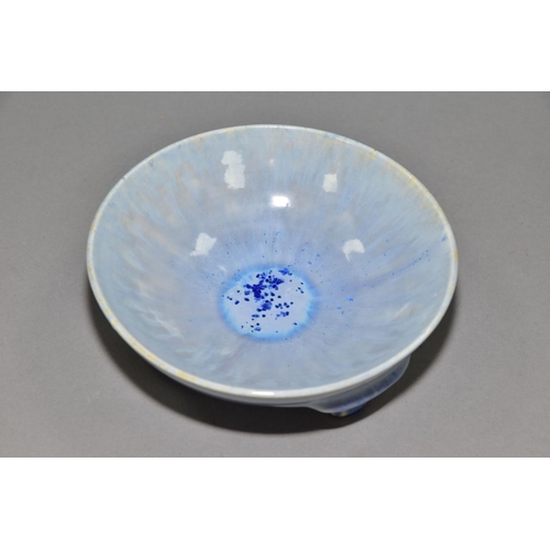 219 - RUSKIN POTTERY, a shallow bowl raised on three feet, blue crystalline and streaked glaze, impressed ... 