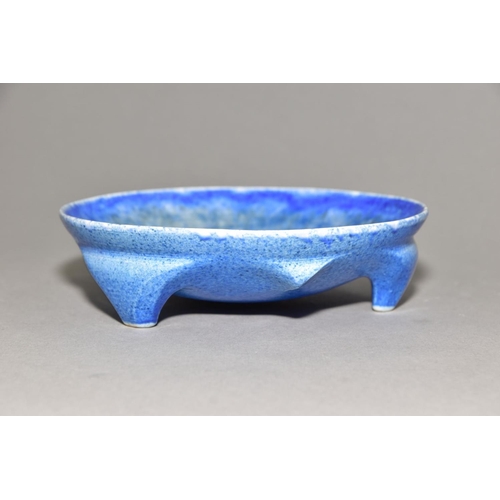 222 - RUSKIN POTTERY, a shallow bowl raised on three feet, blue crystalline glaze, impressed Ruskin Englan... 