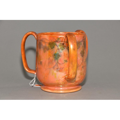 227 - RUSKIN POTTERY, a three handled tyg decorated in orange lustre with a band of underglazed foliate de... 