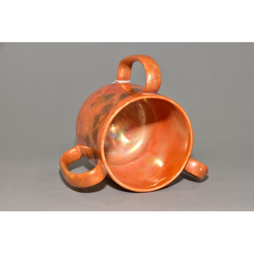 227 - RUSKIN POTTERY, a three handled tyg decorated in orange lustre with a band of underglazed foliate de... 