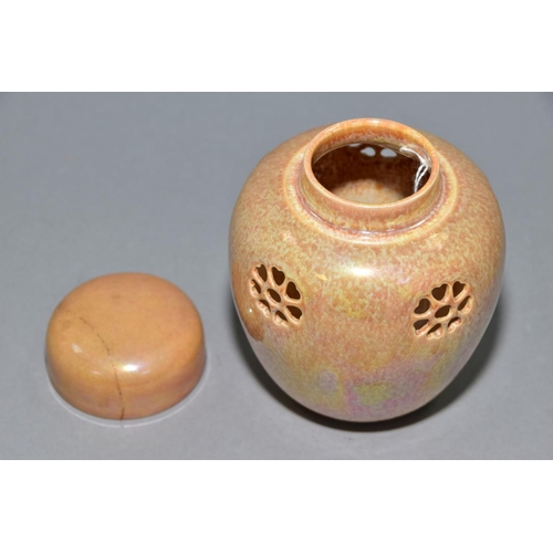 232 - RUSKIN POTTERY, a peach lustre reticulated ginger/pot pourri jar with cover, the body pierced with f... 