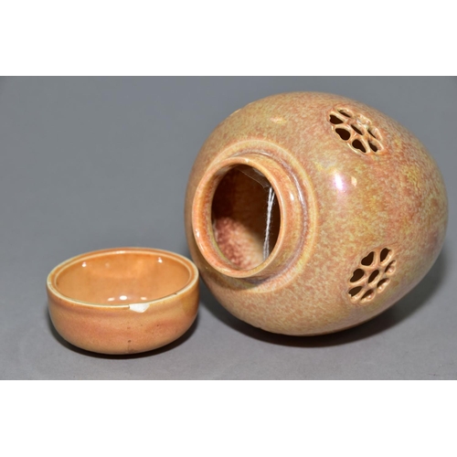 232 - RUSKIN POTTERY, a peach lustre reticulated ginger/pot pourri jar with cover, the body pierced with f... 