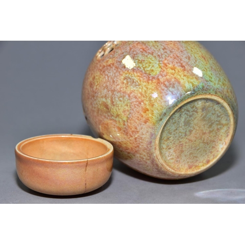 232 - RUSKIN POTTERY, a peach lustre reticulated ginger/pot pourri jar with cover, the body pierced with f... 