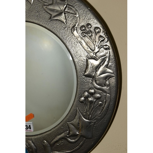 234 - AN ARTS & CRAFTS STYLE CIRCULAR PEWTER FRAMED MIRROR, inset with bevel edged glass to the centre and... 