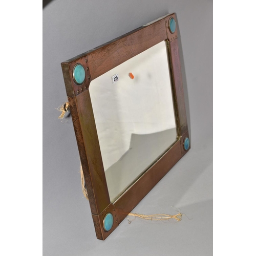 235 - AN ARTS & CRAFT STYLE RECTANGULAR COPPER FRAMED MIRROR, inset with four Ruskin style circular plaque... 