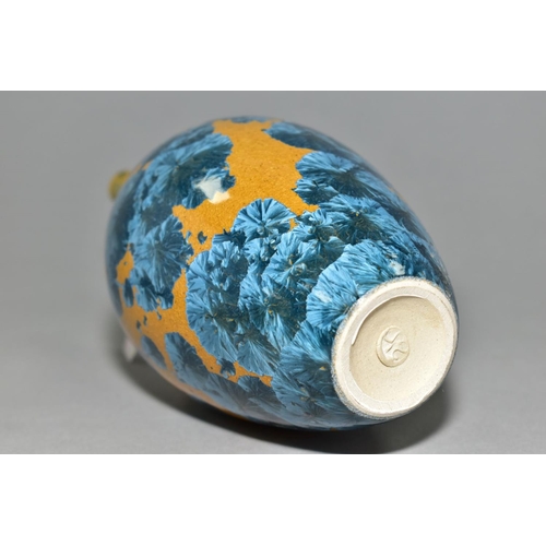 27 - A SIMON RICH (BORN 1949) STUDIO POTTERY CRYSTALLINE GLAZED OVOID BOTTLE VASE, ochre ground with blue... 