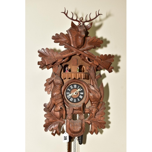 28 - A SECOND HALF 20TH CENTURY WOODEN CUCKOO CLOCK, the case carved with gabled roof, Stag's head, hare,... 