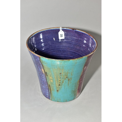 35 - A DARTINGTON POTTERY CONICAL JARDINIERE, decorated with wide vertical bands of turquoise, blue and r... 