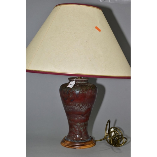 7 - A COBRIDGE STONEWARE HIGH FIRED BALUSTER TABLE LAMP, mottled green/blue glaze over a red ground, mou... 