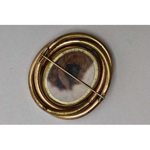 114 - THREE ITEMS OF VICTORIAN JEWELLERY, to include an oval memorial brooch with central double sided swi... 