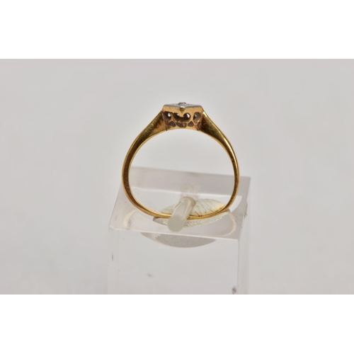 131 - A YELLOW METAL SINGLE STONE DIAMOND RING, misshapen shank, set with a single cut diamond, within a s... 