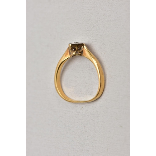 131 - A YELLOW METAL SINGLE STONE DIAMOND RING, misshapen shank, set with a single cut diamond, within a s... 