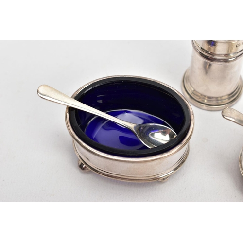 163 - A THREE-PIECE SILVER CONDIMENT SET, comprising of a salt and mustard each with a blue glass lining, ... 