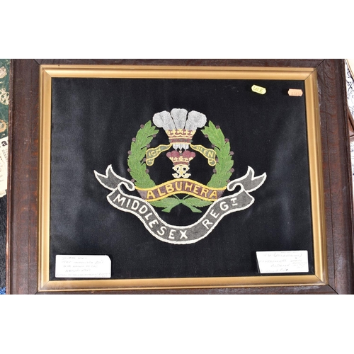 84 - A GLASS FRAMED EMBROIDERED WWI ERA REGIMENTAL CREST OF THE MIDDLESEX REGIMENT. size approximately 42... 