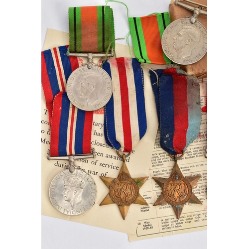 94 - A BOXED GROUP OF FOUR WWII MEDALS to include 1939-45, Italy Stars, Defence & War medal with award sl... 