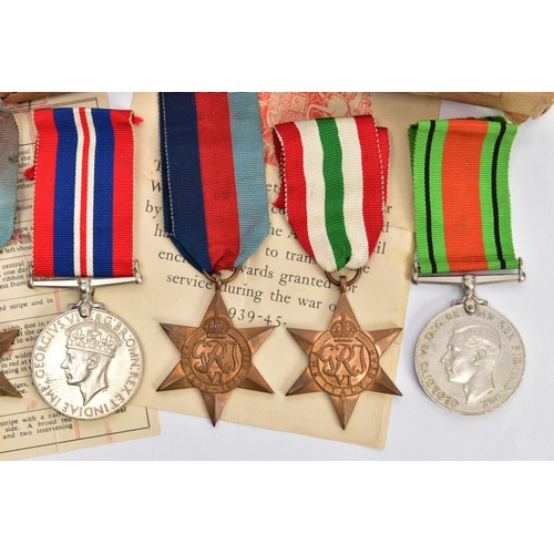 94 - A BOXED GROUP OF FOUR WWII MEDALS to include 1939-45, Italy Stars, Defence & War medal with award sl... 