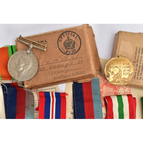 94 - A BOXED GROUP OF FOUR WWII MEDALS to include 1939-45, Italy Stars, Defence & War medal with award sl... 