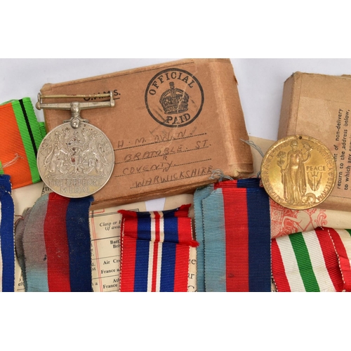 94 - A BOXED GROUP OF FOUR WWII MEDALS to include 1939-45, Italy Stars, Defence & War medal with award sl... 