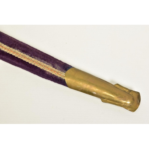 95 - AN INDIAN MADE CURVED SWORD, in a wooden scabbard trimmed with purple coloured velvet style cloth wi... 