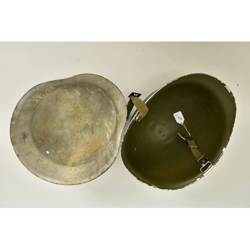 97 - TWO MILITARY HELMETS to include a USA Pattern M1 helmet in Green, strap complete but no internal lin... 