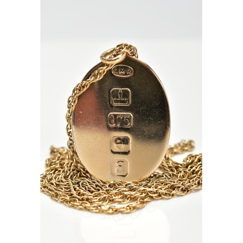 160 - A 9CT GOLD PENDANT AND CHAIN, the oval pendant with large hallmark stamped vertically to one side an... 