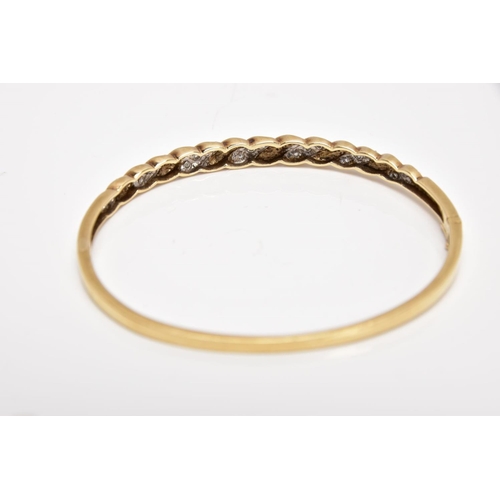 165 - A 9CT GOLD DIAMOND SET HINGED BANGLE, of twist design, set with diagonal sections of single cut diam... 