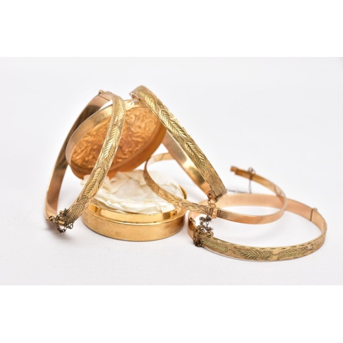 180 - FOUR ROLLED GOLD HINGED BANGLES, each with an engraved foliate or scroll design, each with slide loc... 