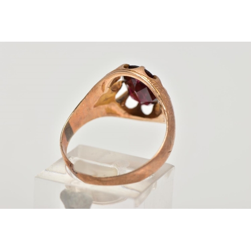 182 - A 9CT GOLD GARNET SIGNET RING, designed with a claw set, oval cut garnet, openwork surround, worn fl... 