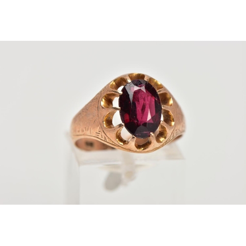 182 - A 9CT GOLD GARNET SIGNET RING, designed with a claw set, oval cut garnet, openwork surround, worn fl... 