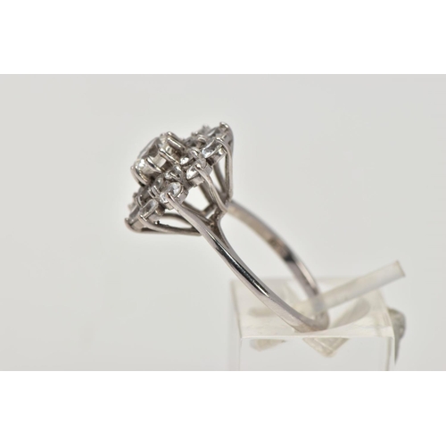 186 - A WHITE METAL SPINEL CLUSTER RING, slightly raised, large flower shape cluster, set with circular cu... 