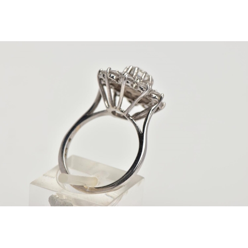 186 - A WHITE METAL SPINEL CLUSTER RING, slightly raised, large flower shape cluster, set with circular cu... 