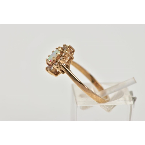 198 - A 9CT GOLD OPAL CLUSTER RING, designed as a central oval opal cabochon within a circular cut cubic z... 