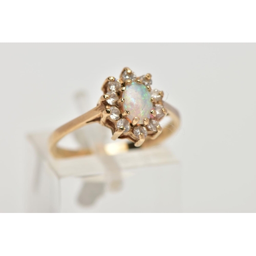 198 - A 9CT GOLD OPAL CLUSTER RING, designed as a central oval opal cabochon within a circular cut cubic z... 