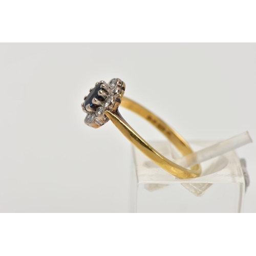 199 - AN 18CT GOLD SAPPHIRE AND DIAMOND CLUSTER RING, the central oval sapphire in a ten claw setting with... 