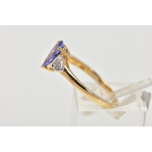 201 - A 9CT GOLD TANZANITE AND DIAMOND RING, the central pear shape tanzanite in a three claw setting, eac... 