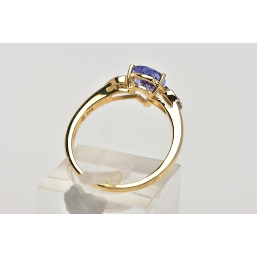 201 - A 9CT GOLD TANZANITE AND DIAMOND RING, the central pear shape tanzanite in a three claw setting, eac... 