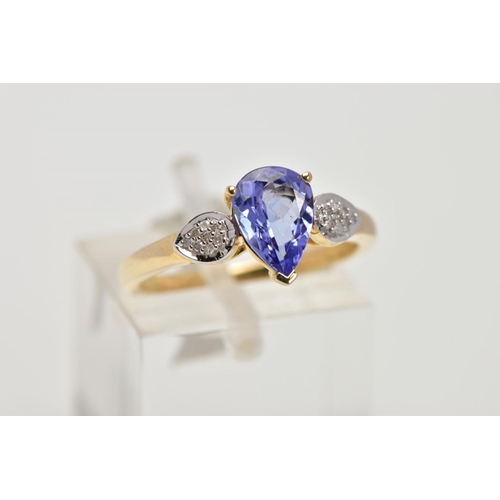 201 - A 9CT GOLD TANZANITE AND DIAMOND RING, the central pear shape tanzanite in a three claw setting, eac... 