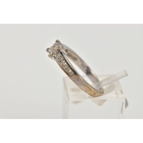 206 - A 9CT WHITE GOLD DIAMOND RING, designed as a central square of four princess cut diamonds with six b... 