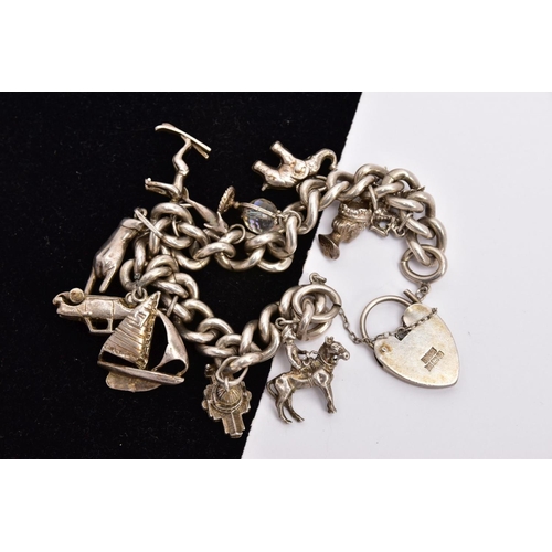 210 - A SILVER CHARM BRACELET, the curb link bracelet suspending a total of eleven charms to include a glo... 