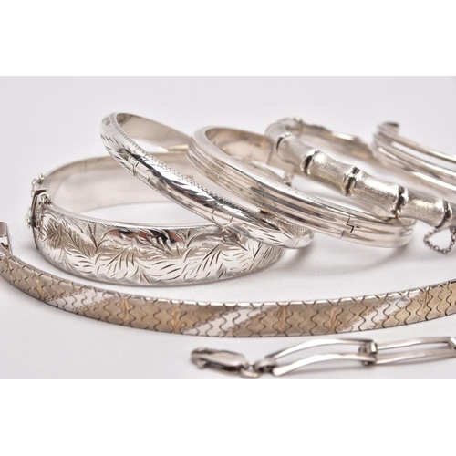 212 - A PARCEL OF SILVER AND WHITE METAL BANGLES AND BRACELETS, to include a wide silver hinged bangle, de... 