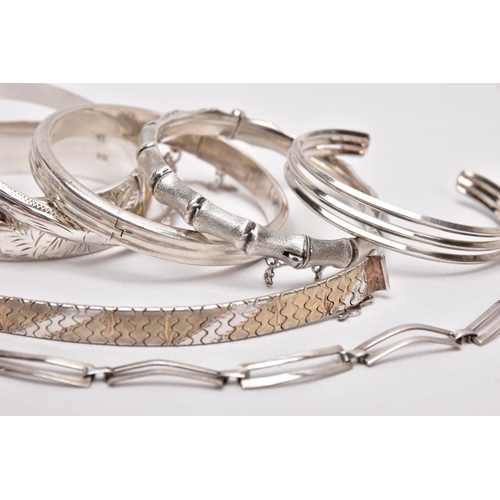 212 - A PARCEL OF SILVER AND WHITE METAL BANGLES AND BRACELETS, to include a wide silver hinged bangle, de... 