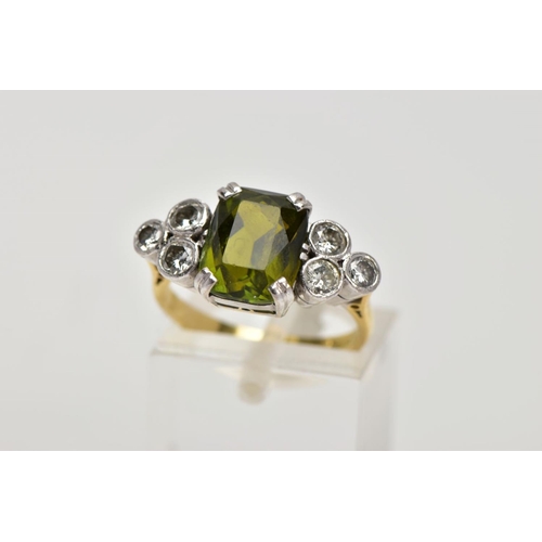 254 - AN 18CT GOLD TOURMALINE AND DIAMOND DRESS RING, centring on an emerald cut green tourmaline, flanked... 